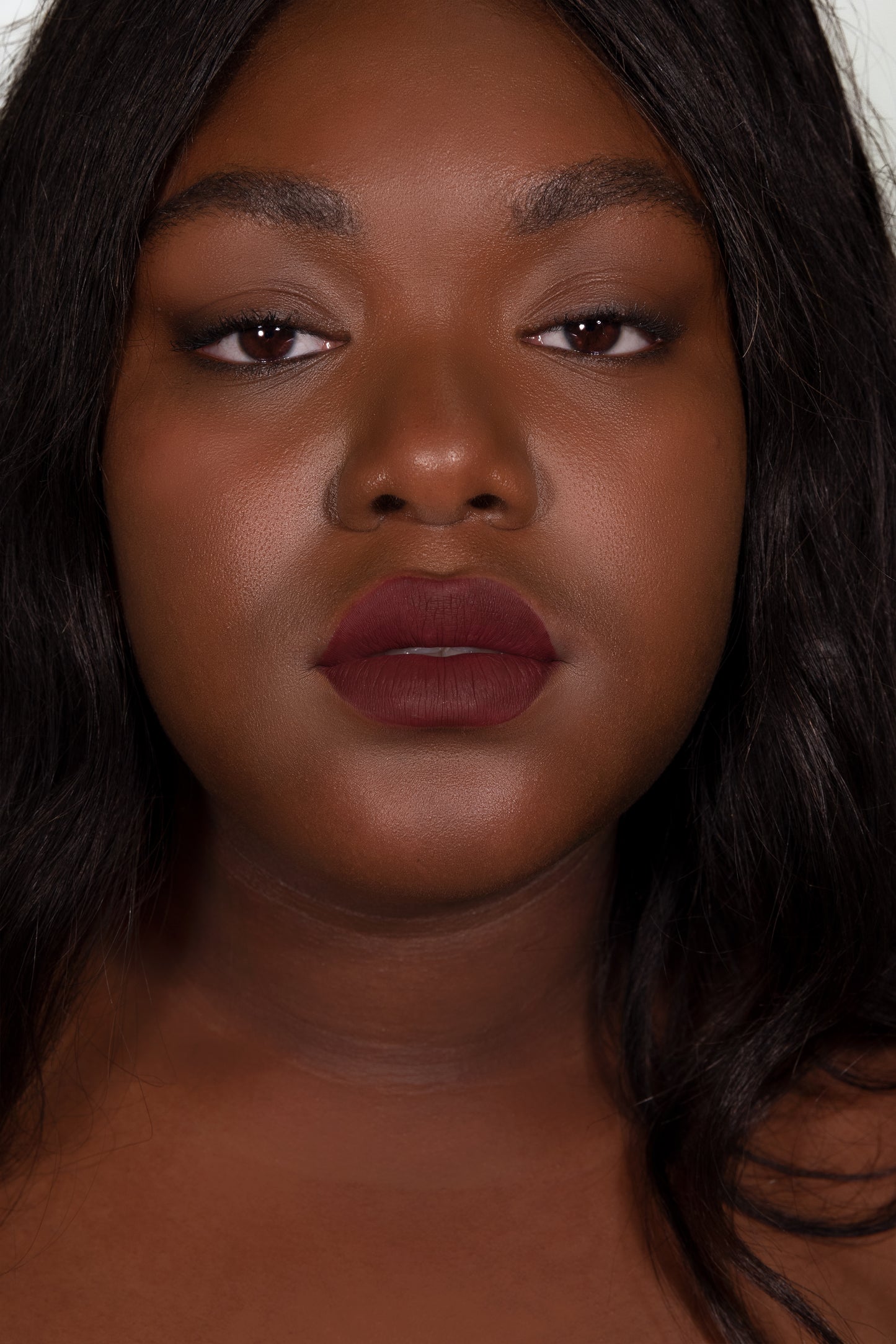 Close up of model wearing purple liquid lipstick of the brand DUTCH. Cosmetx. 
